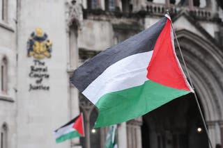 Protesters holding Palestinian flags outside the Royal Courts of Justice on Friday (Jonathan Brady/PA).